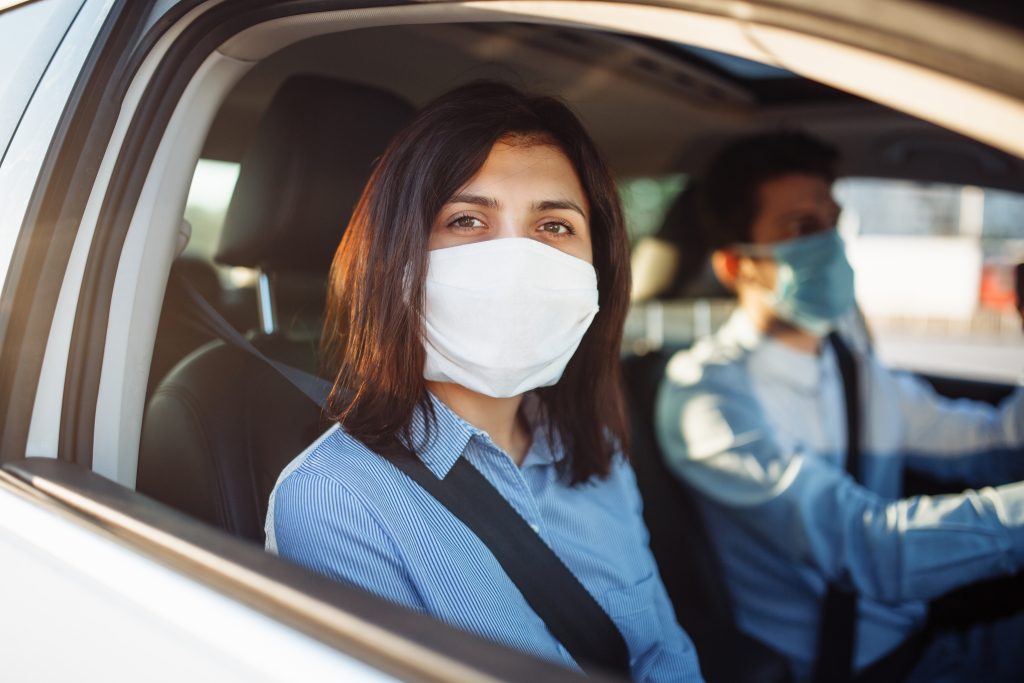 young girl passenger takes ride by taxi during the coronavirus pandemic quarantine Coaching financier